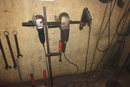 Miscellaneous power tools and hand tools on the wall, including angle grinder, Metabo, ø 125 + grinder AEG WS 1801