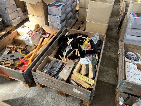 Pallet with various broom heads and brooms