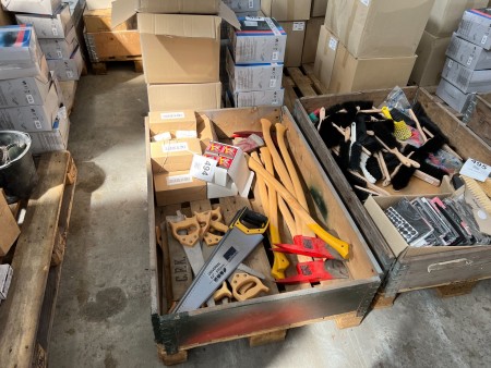 Pallet with various tools, axes, saws and string