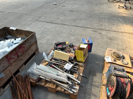 Pallet with various screw clamps, saw, earplugs, etc.