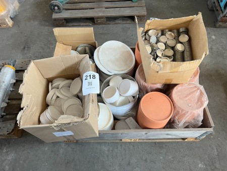 Pallet containing various lids for paint buckets