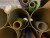 9 tubes containing various textiles & types of fabric