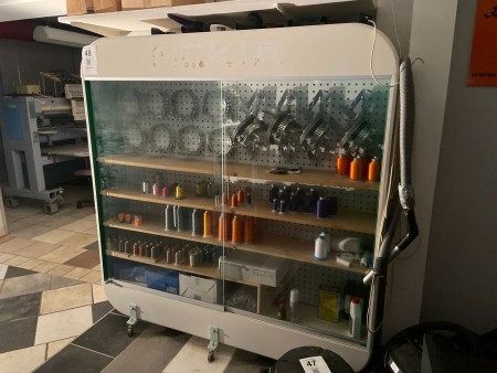 Cabinet on wheels containing various accessories, spare parts, etc. for embroidery machines