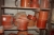 Large batch of PVC fittings, various diameters, in shelves and on the floor under the rack and box shelves along the wall