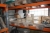 Content in one section pallet racking and on the floor below 1 section pallet racking
