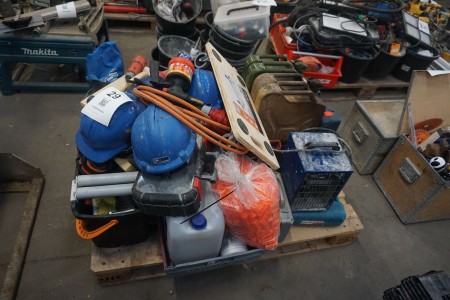 Pallet with various safety helmets, jerry cans, heat lamps. heat gun, etc.