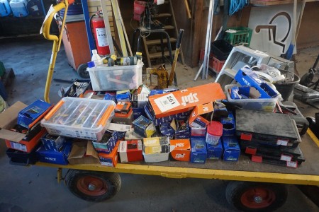 Contents on cart of various screws, nails, building materials, etc.