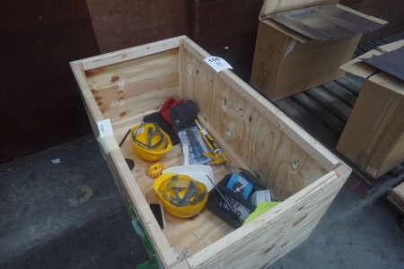 Box with various safety helmets, pop rivet sets, etc.