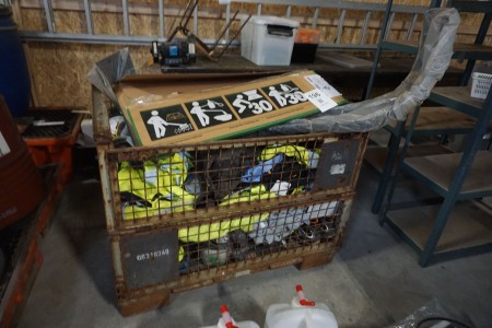 Pallet cage with various work clothes, safety helmets, etc.