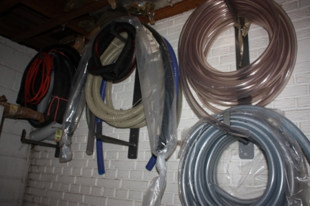 Miscellaneous hoses on the wall + steel rack with content