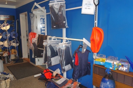 Shop display rack with various life vests + marking buoys + safety ropes etc.
