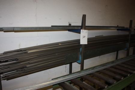 Shelving at the wall containing semi-finished stainless goods, length approx. 5 meters