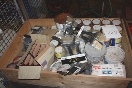 Pallet with various paints, brushes, sanding belts, etc.