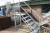Galvanized stair landing. Unused. 7 steps. Height to landing approx. 1233 mm. Can be fitted with transport wheels (which may be purchased separately from the seller)