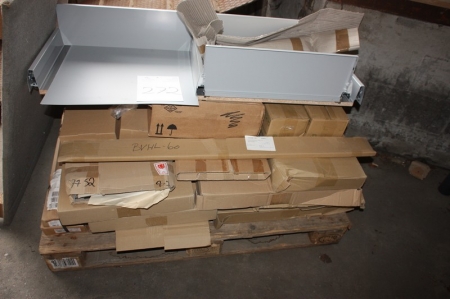 Various parts on a pallet, including parts for cabinet drawers