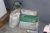 Work table with various packing material bags + film + various bags of cement (broached)