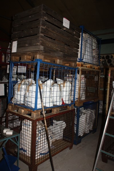 6 tall cages containing plastic components for seeders