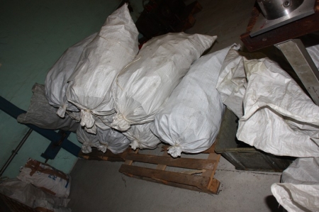 Approximately 16 bags of plastic components for seeders
