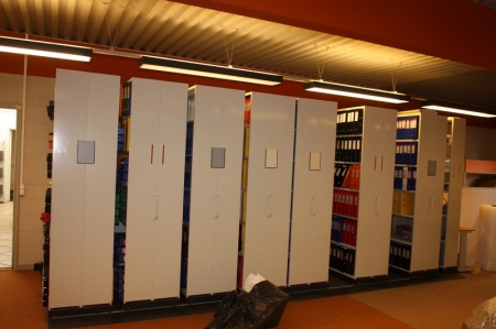 Archive shelving on rails, 7 sections, double sided + 1 section, single sided + content: many empty binders. Stuffed binders and other paper to be loaded into the container at the exit)