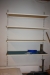 Wall shelf + table with content: Scotchtape, wrapping paper, bubble envelopes, plastic film, gummed envelopes, etc.