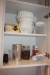Various crockery, cutlery, etc. in kitchen cabinets and on top of kitchen cabinets