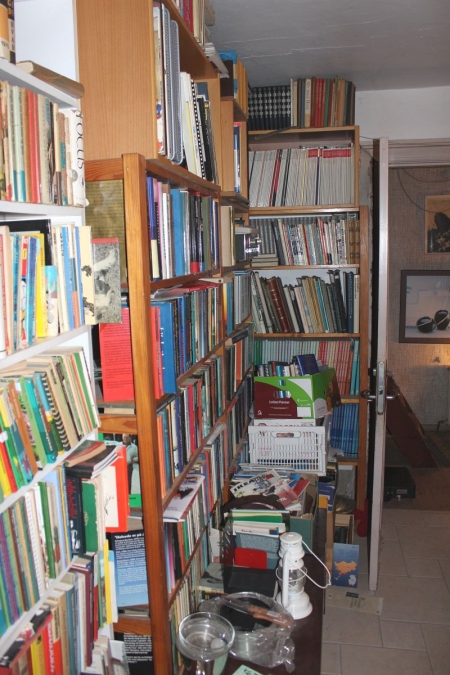 Room with content. Bookcases, books, computer, cabinet