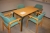 Table and 4 chairs with green cloth cover