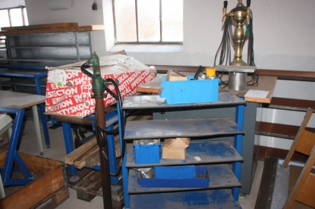 Table with draft beer dispensing tap + tool cart + pipe sections in box + oil pump + foot operated hydraulic lift truck