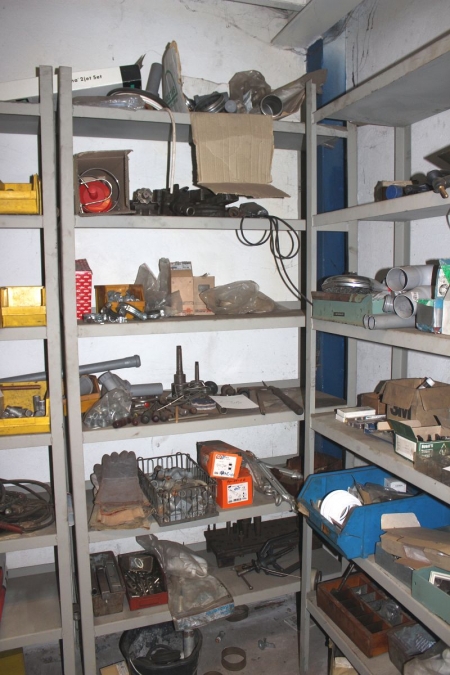 Shelf containing various hand tools + pipe supports, etc.