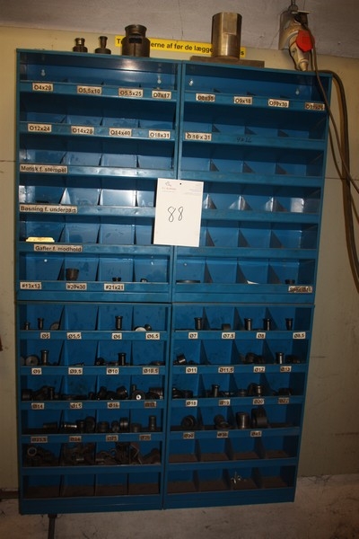 4 bolt racks on the wall with content including puncher tools