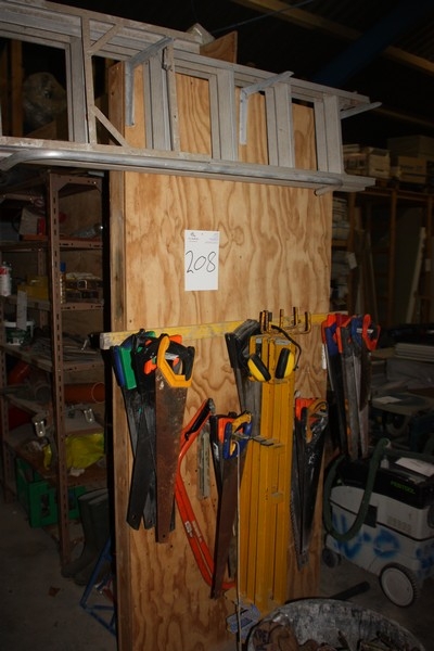 3 scaffolding ladders + saws etc. on wall + mason tub of contents