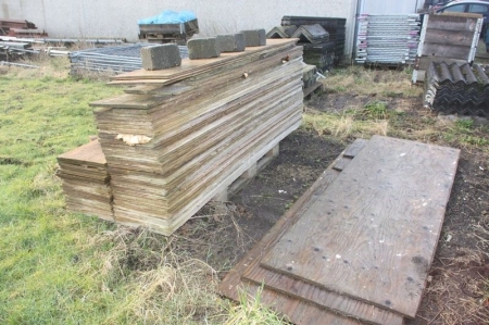 Pallets with plywood panels on site