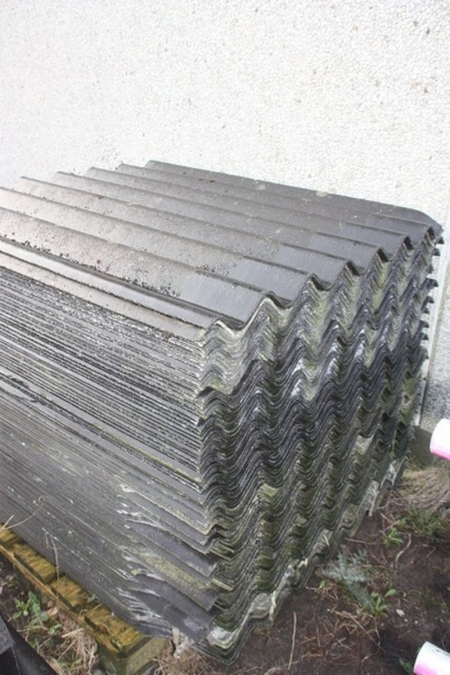 Pallets with second hand asbestos roof panels on site