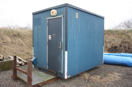 Toilet pavillon with toilet, shower and sink. In need of maintenance. Container hoist