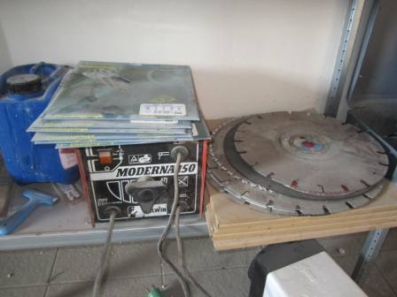 Small welder and various used and new diamond cutting blades, circular saw blades, etc.