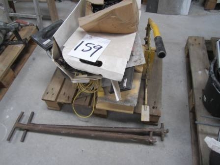 Pallet with stone cutter, floats and other masonry accessories
