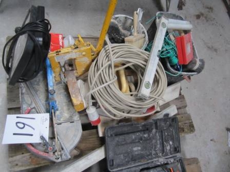 Pallet with work light, tile cutter, stone cutter, floats and other masonry tools