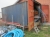20 foot shipping container, somewhat rusty, Eksl. Hagi scaffold on which it stands