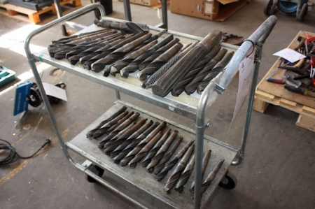 Roller table with various drills and milling tools
