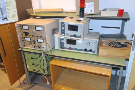 Table with various testing devices + cabinet with content
