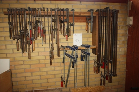 Various clamps on wall + 4 wooden boxes with contents