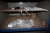 Arbejdsbord med metalplade, ca. 2000 x 1000 mm + skruestik + værktøjstavle med lys + indhold, bl.a. bolte, møtrikker, spændskiver, gevindstænger med videre + 2 træbukke + diverse skabe