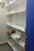 Wall mounted steel rack with approx. 30 shelves containing various office supplies
