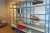 All in depot 1, steel shelving with content + racking + cabinets + trolleys containing various kitchen service (less lot No. 275 and fixed installations)