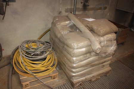 Pallet with sand for sand blowing in plastic bags + pallet with a rubber hose + air hoses + hoses on the wall + pallet with sealing plugs