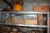 3 span steel shelving in container + content, including gas bottle + electrical parts on the floor below and in front steel rack