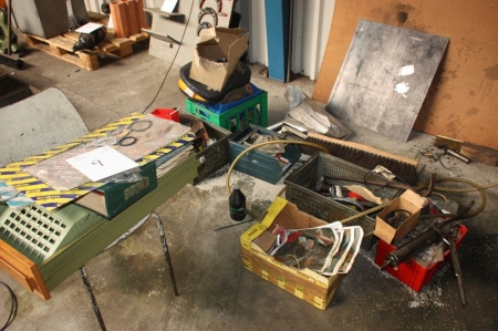 Various items on the floor, including gaskets, grease gun, cutting discs, etc.