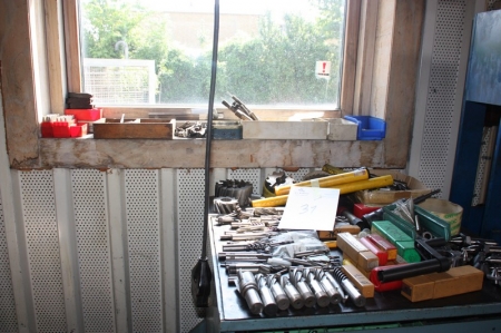 Various parts of the cabinet and window sill, including milling tool, cutting tool, screw tabs, punch tools etc.