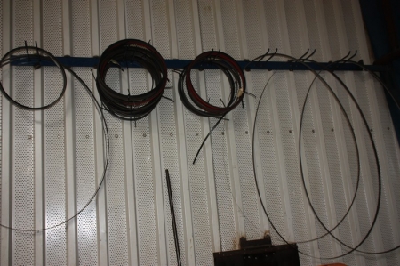 Various blades for bandsaw on wall including holding