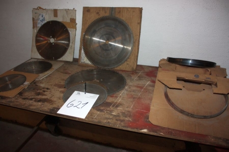 Table with various circular saw blades and bandsaw bands